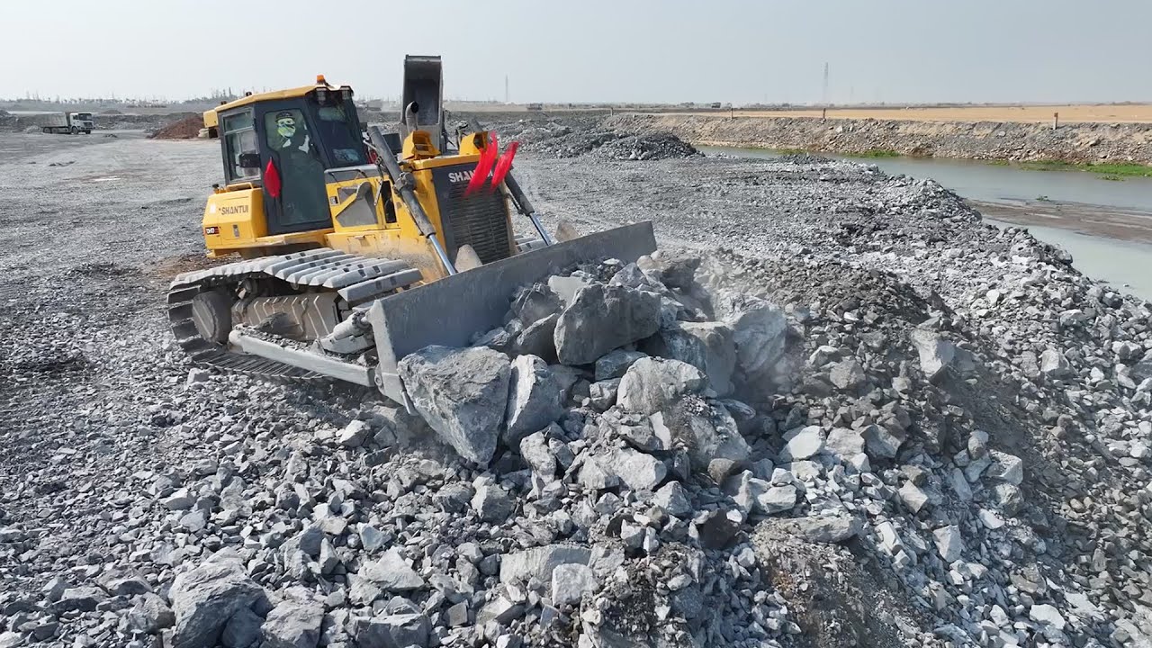 It's unbelievable!! The project to dump large rocks into the lake must be continued by bulldozers.
