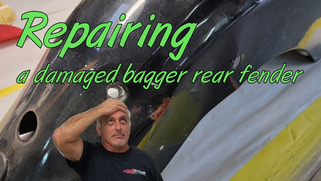 Doing auto bodywork on a creased and dented Harley motorcycle fender