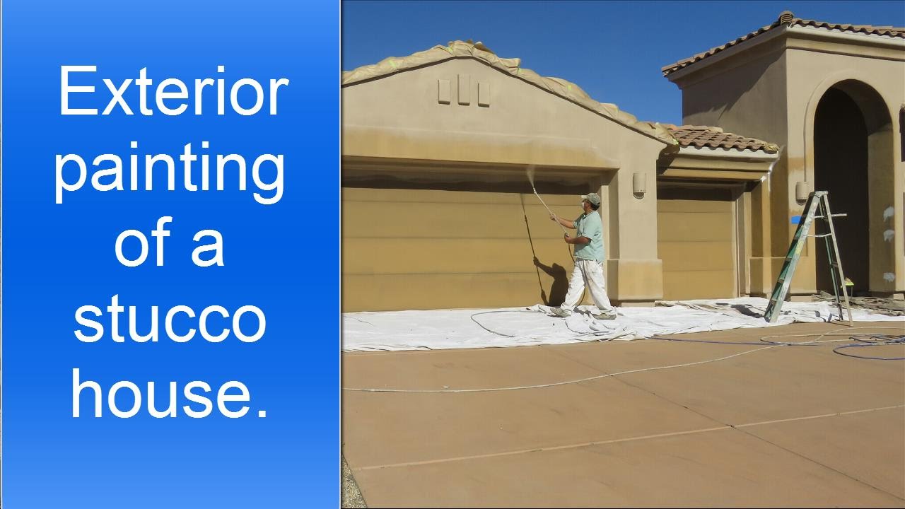Spray painting exterior of a stucco house.