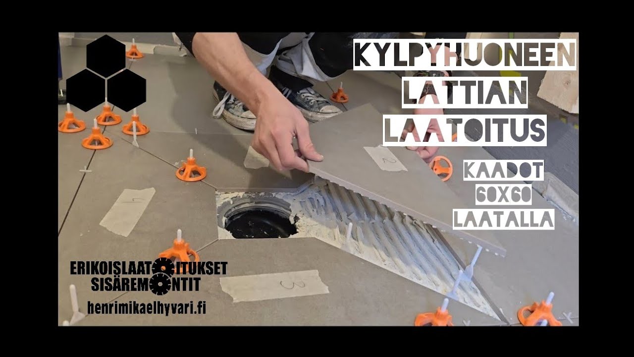 Pistekaivollisen kaatolattian laatoittaminen suurlaatalla.Point drain large format tile installation