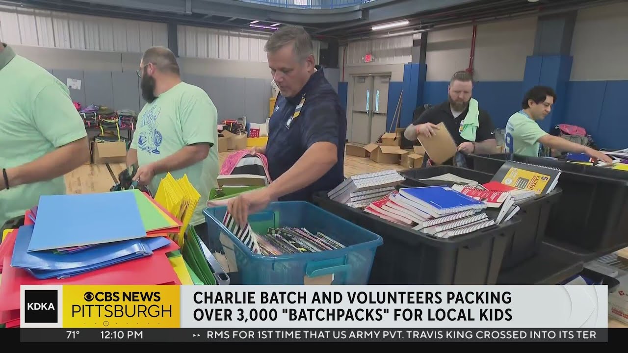 Charlie Batch and volunteers packing over 3,000 