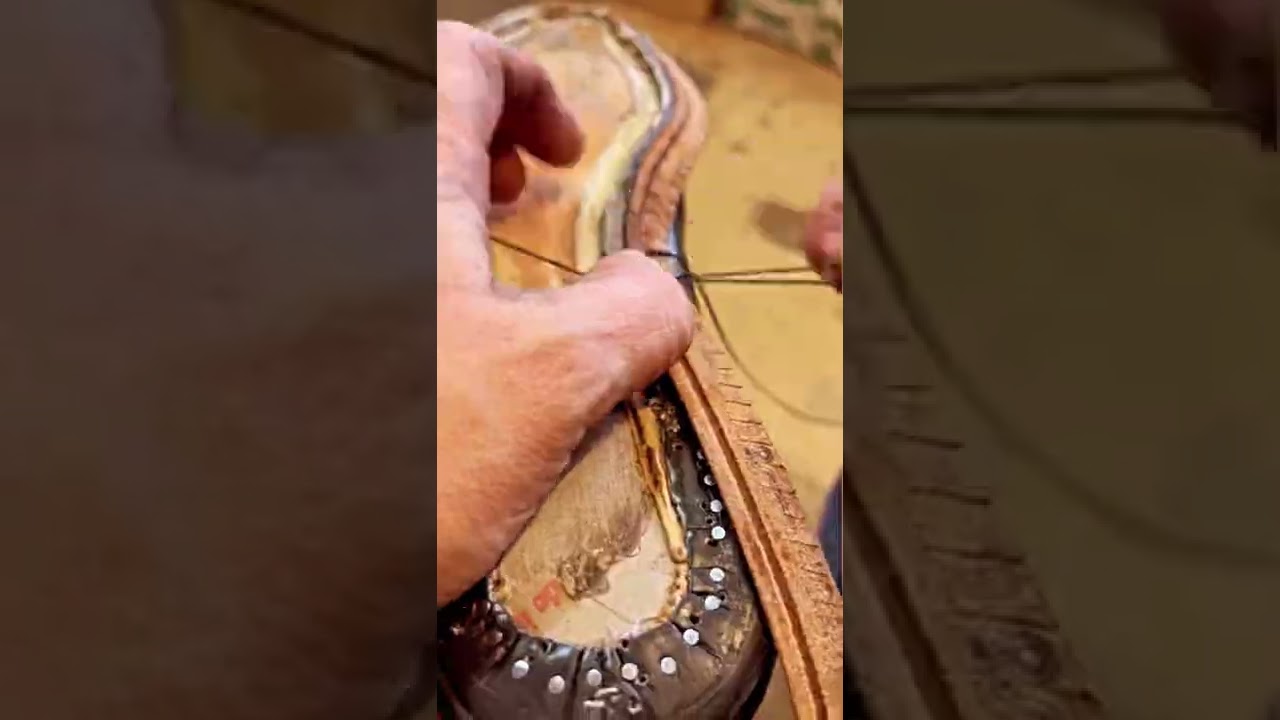 Hand stitching a new leather welt on a pair of goodyear welted shoes.