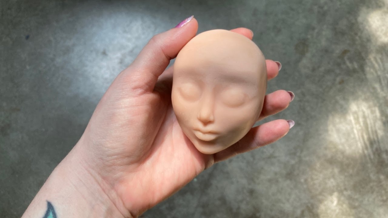 Sculpting a doll head  base out of polymer clay and tinfoil