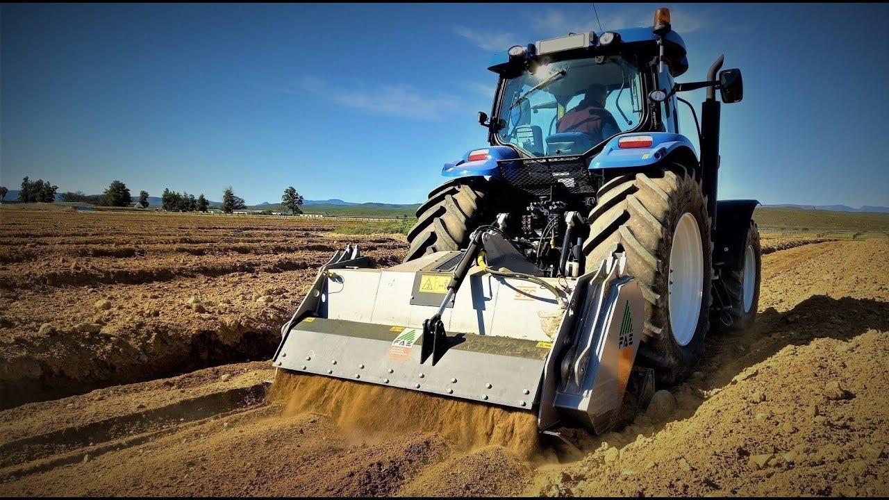 FAE Mulcher STC200DT Stone Crusher behind New Holland T7040 leveling surfaces for new Citrus Orchard