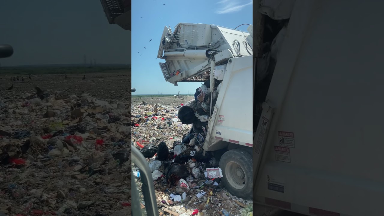 Garbage Truck (Rear Loader) Unloading at Landfill