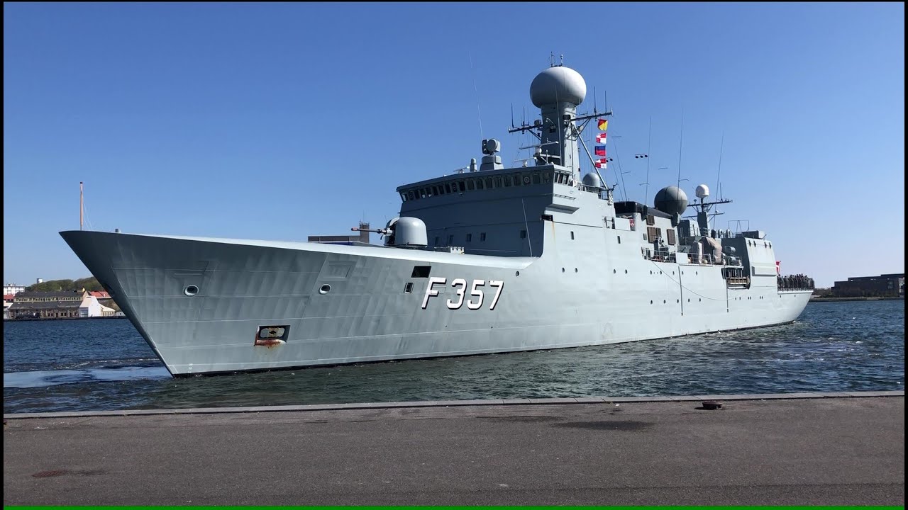 A Danish frigate leaving Aalborg harbor and heading to a fueling dock.