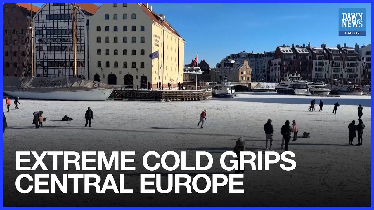 Poles Slip, Slide And Cycle On Frozen River As Extreme Cold Grips Central Europe
