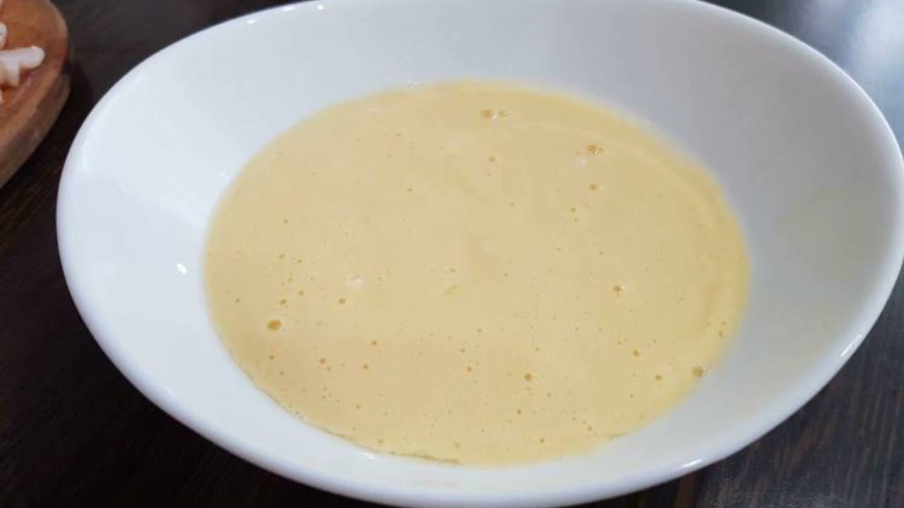 Chicken chops in a frying pan in batter