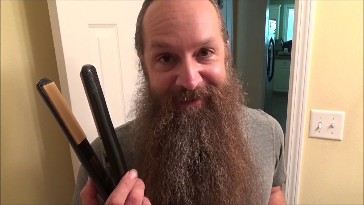 straightening a curly beard with a flat iron