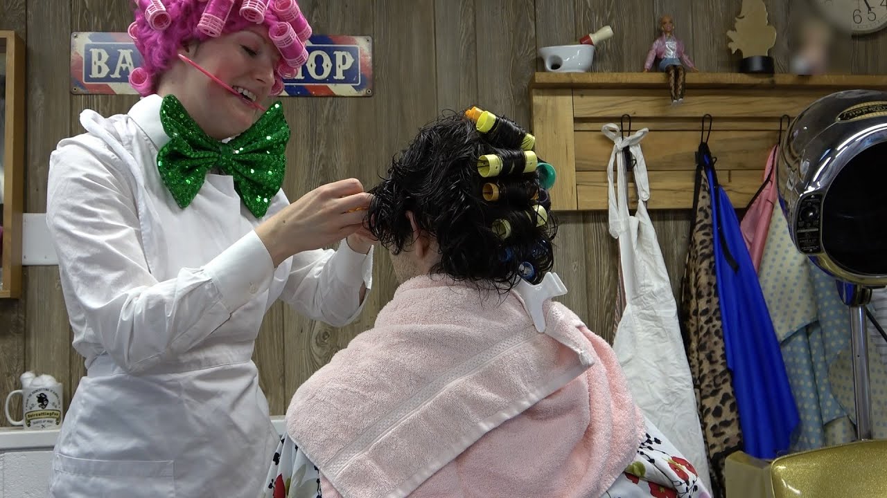 Wife gives husband a roller set in a beauty salon