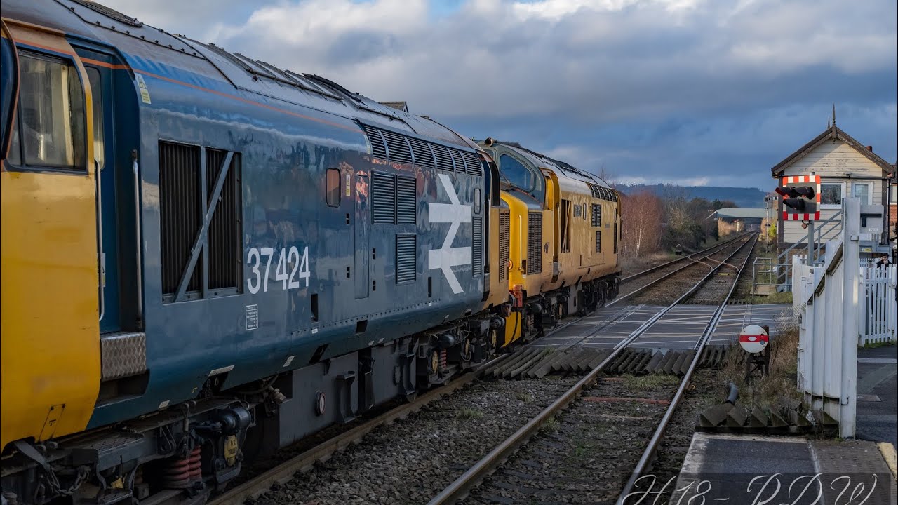 Log train with Locos 97303 & 37424.