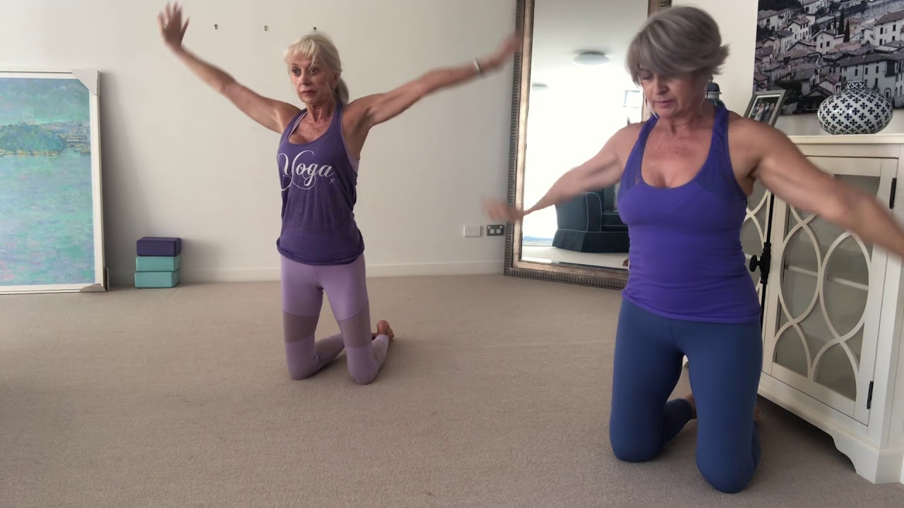Mature students Hands and knees yoga stretching