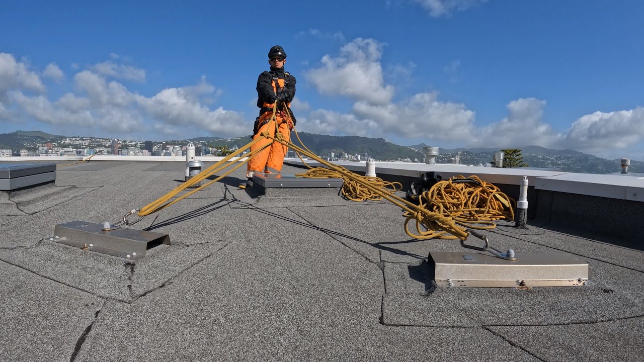 Rope access technician work with amazing view New Zealand.