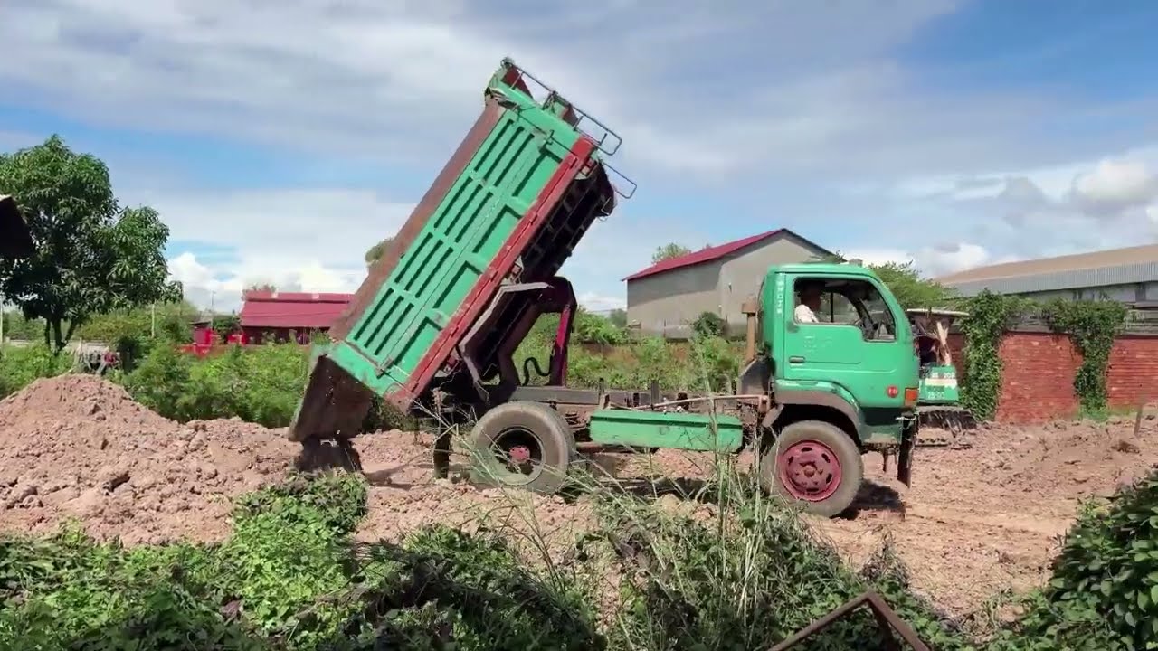 Started​ Processing Filling up land, Road construction, Bulldozer KOMATSU D58E, Dump Truck unloading