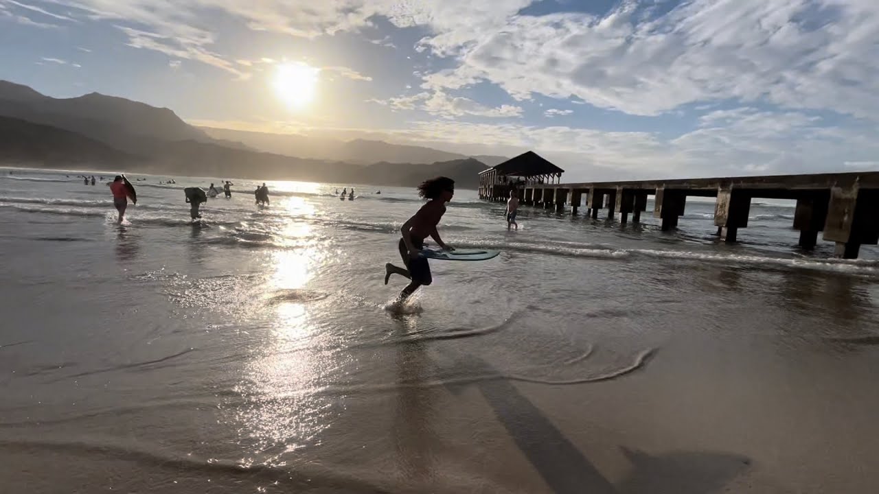 Skimboarding with a Sunset in Hawaii