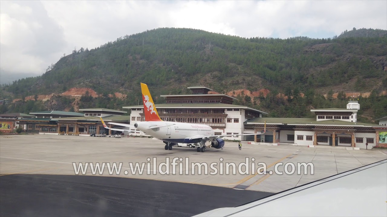 Bhutan's Paro airport: take off on Tashi Group's Bhutan Airlines on steep ascent out of valley