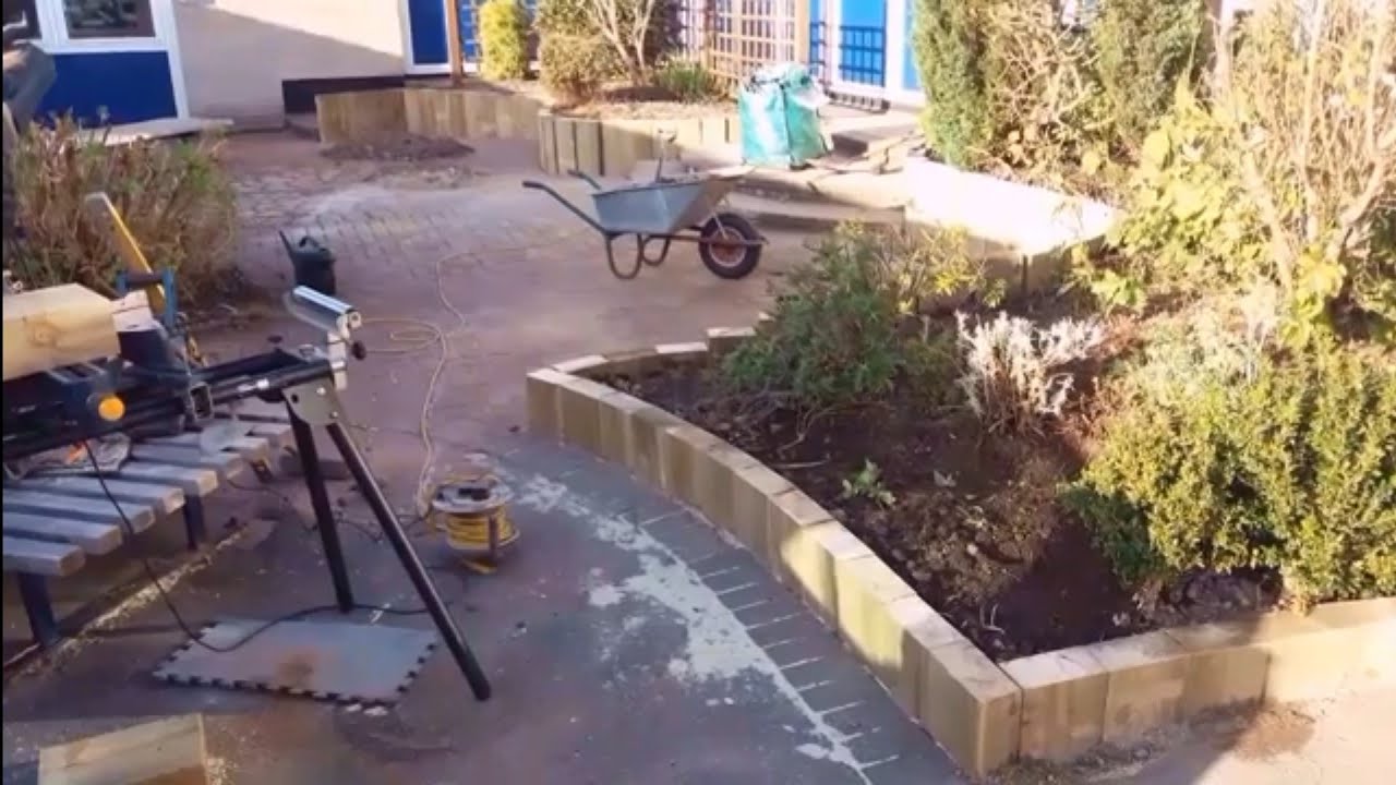 Railway sleeper raised beds for school with incorporated seat.
