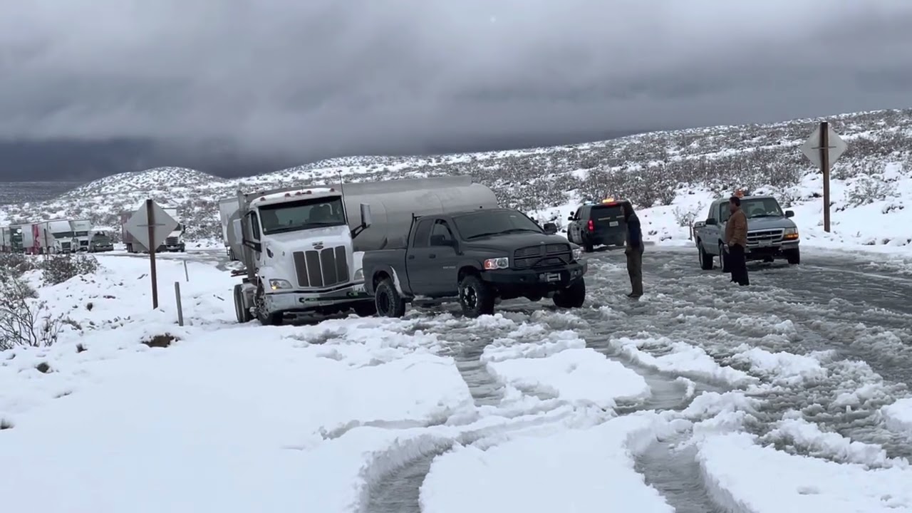‘04 Dodge Ram 2500 pulling a semi tanker uphill out of the snow.