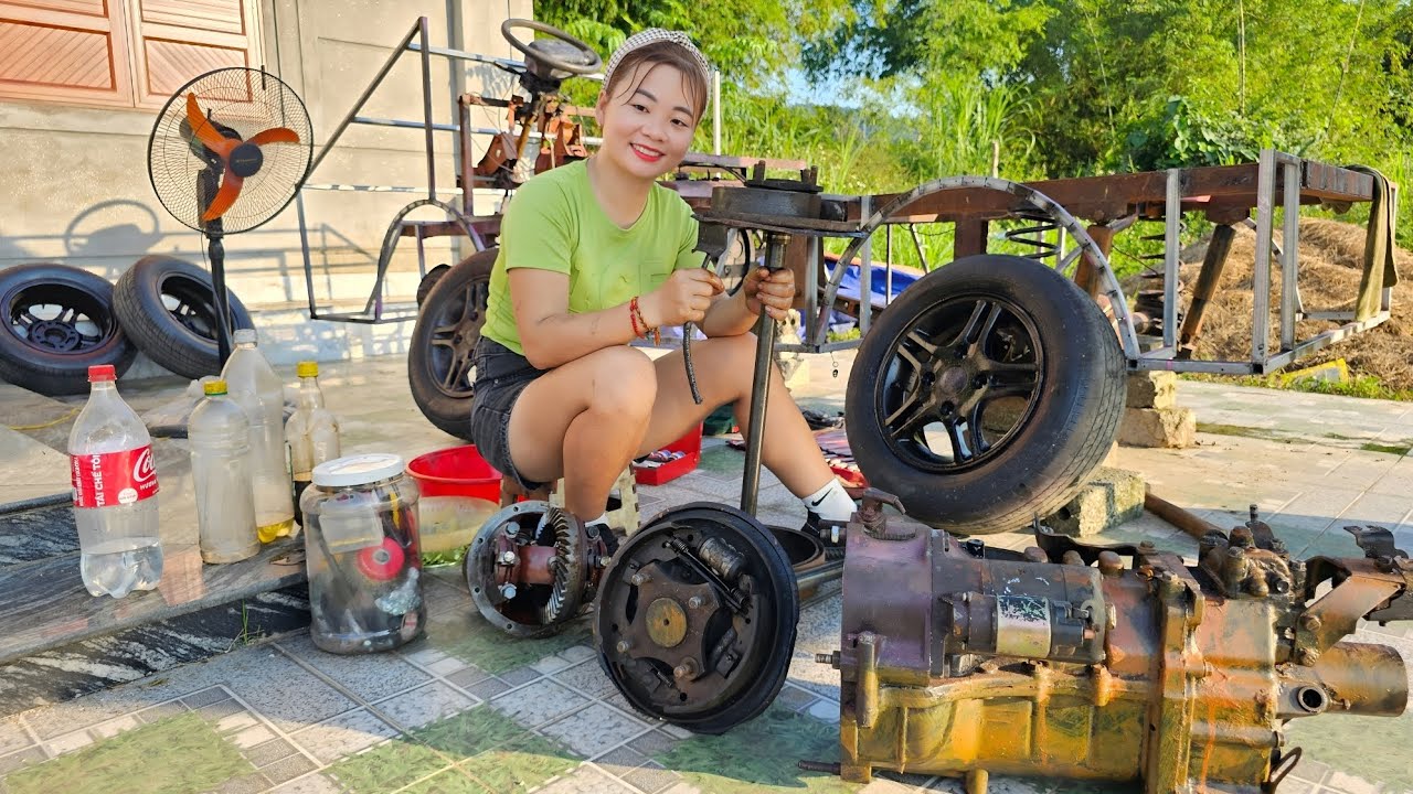 The girl repairs and restores a homemade car for her neighbor.
