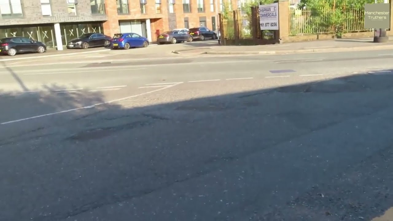 Filling a pothole with both feet at Ordsall, Salford, June 2025. Road surface with zero maintenance.