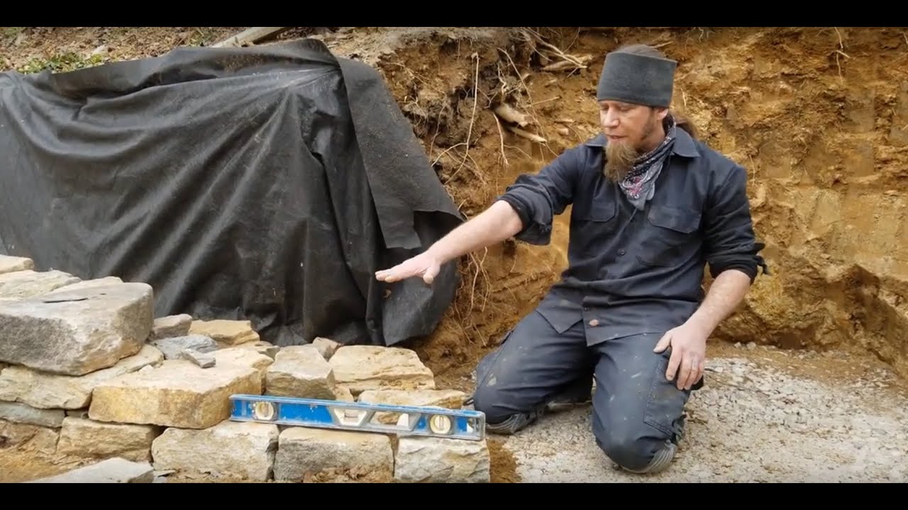building the first course of a dry stone wall | Devin Devine