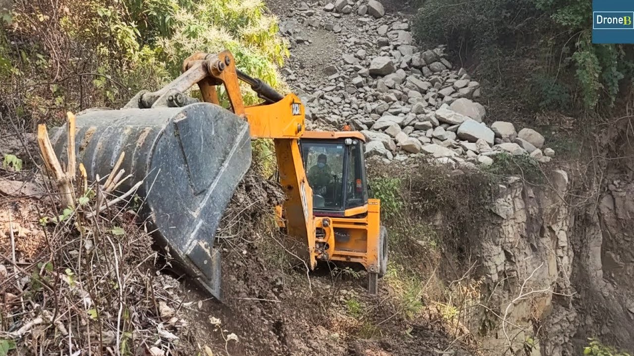 Rocks Flooded Landslide Damaged Mountain Side-Cutting for New Road with JCB