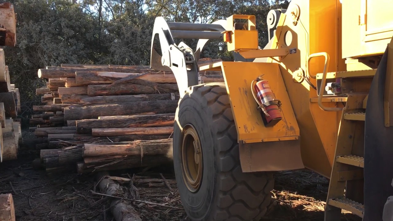 Loading the cradle with logs prior to pushing into the container.