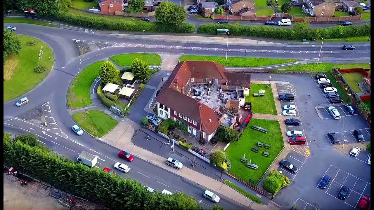 Harvester Restaurant from above and Train crosses Rail Bridge