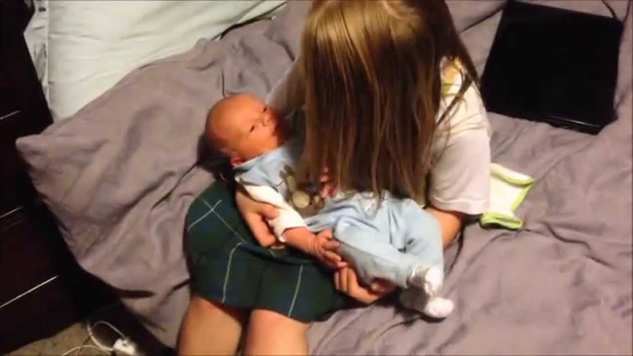 Big sister thinks he's cute!