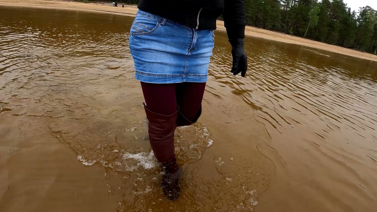 Wet denim skirt and wet high leather boots in deep water