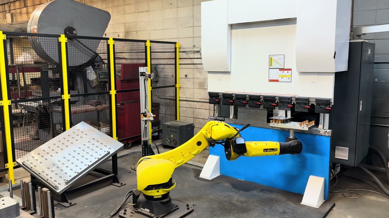 Robotic press tending of sheet metal parts with a Fanuc m20i/25d robot