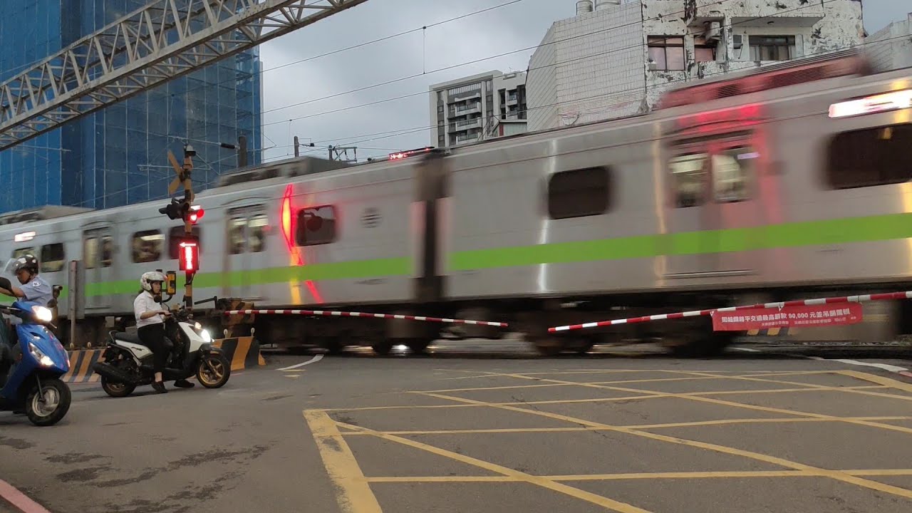 New house on the left, old peeling house on the right, with a level crossing in between.