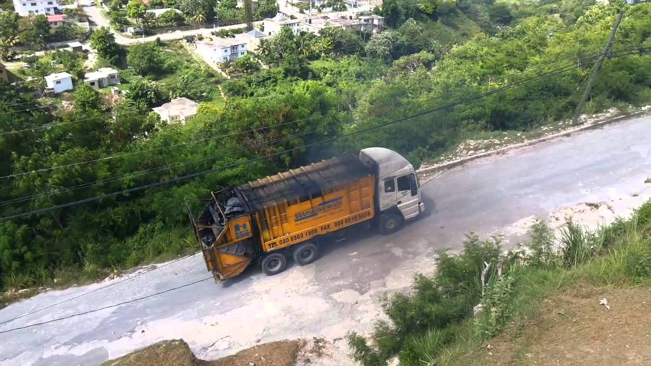 Sedan Atkinson Trash Truck Climbing Hill