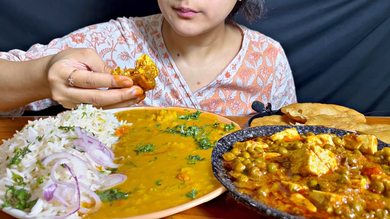 Eating Dal fry, matar paneer, puris, rice