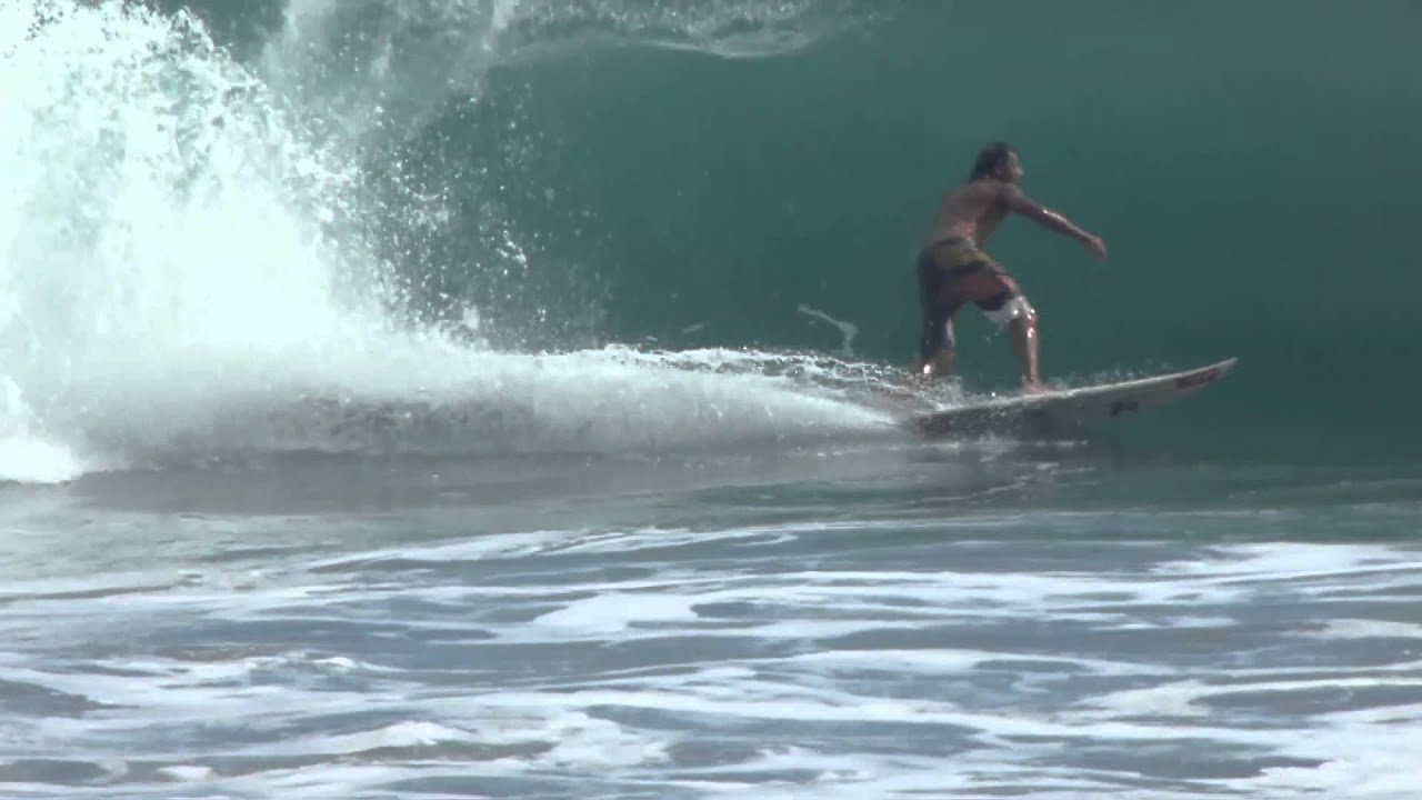 Local Surf Pro Chino rides nice wave at Playa Espadilla, Manuel Antonio, Costa Rica