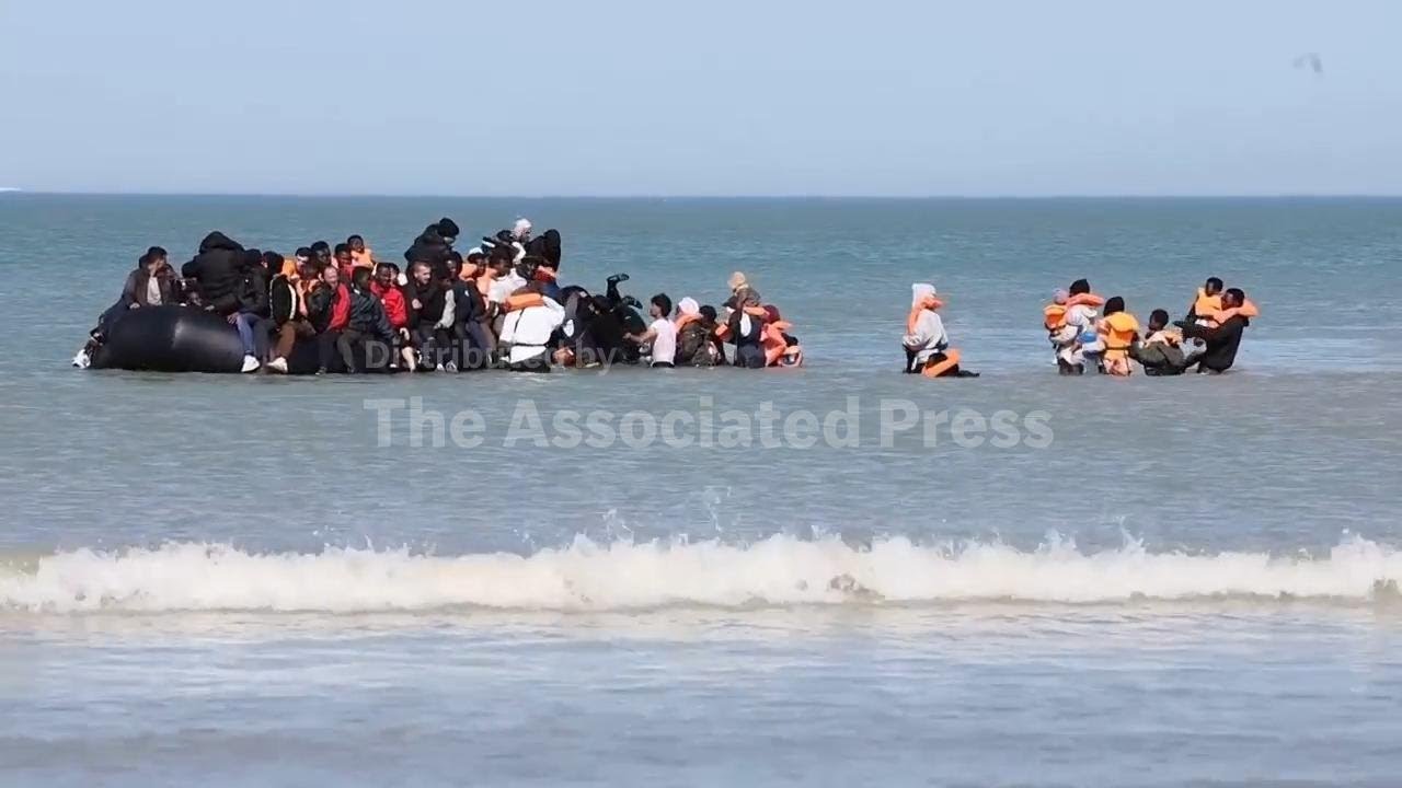 Migrants crowd into small dinghy attempting to leave France for UK