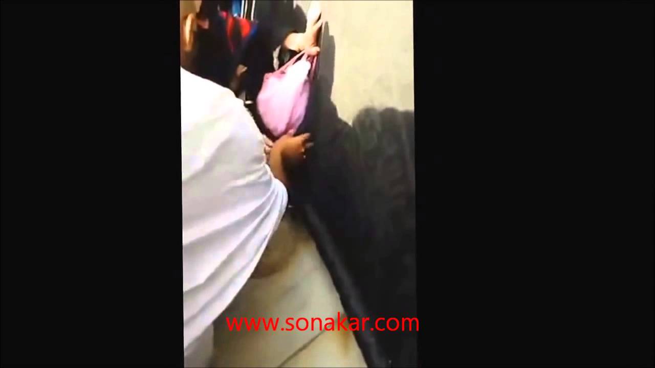 People attempting to remove threads from Kiswah at Kaaba