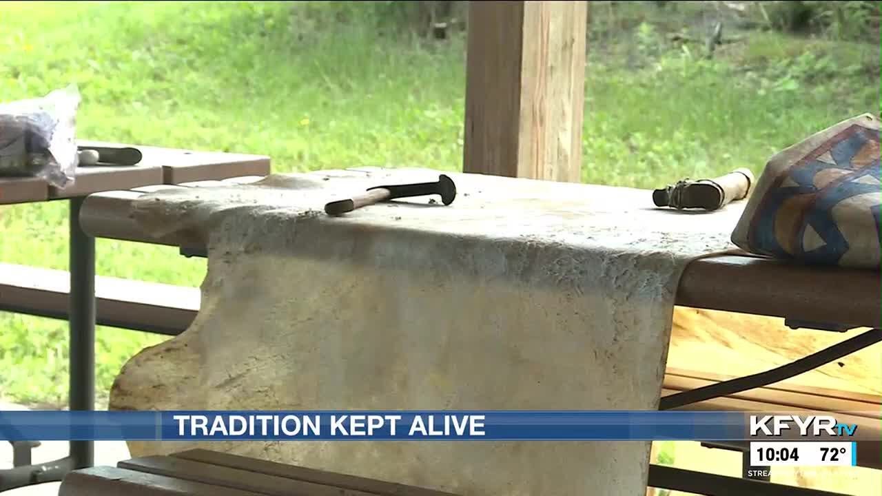 Cultural anthropologist demonstrates parfleche envelope making process