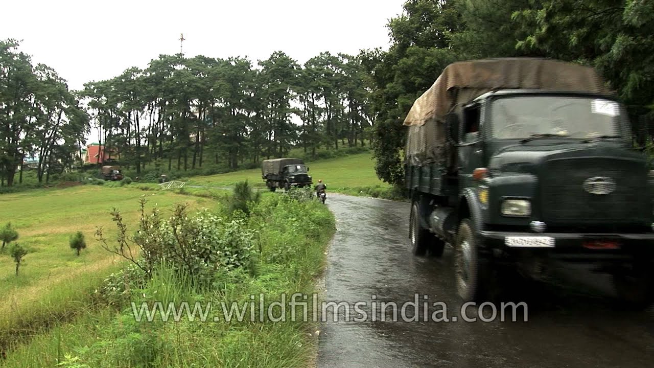 Border Security Force convoy of Ashok Leyland and Tata trucks passes through rainy Shillong