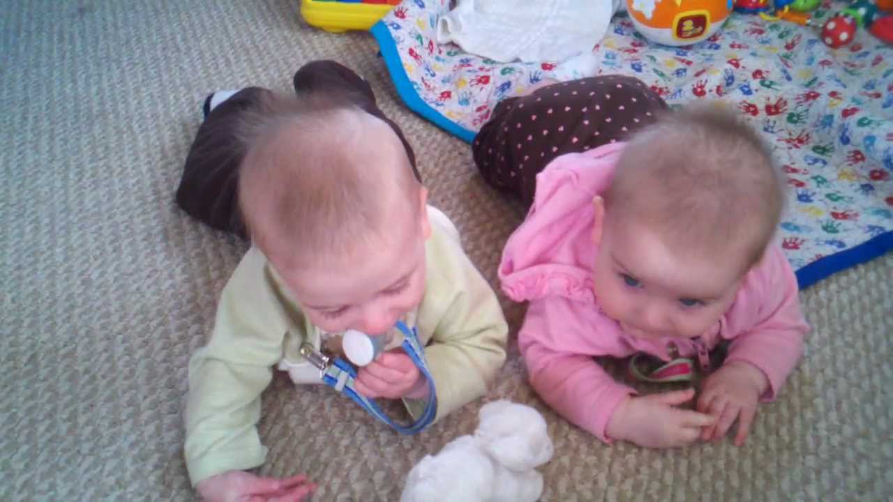 7 month old twins.  Erin picking on her brother.
