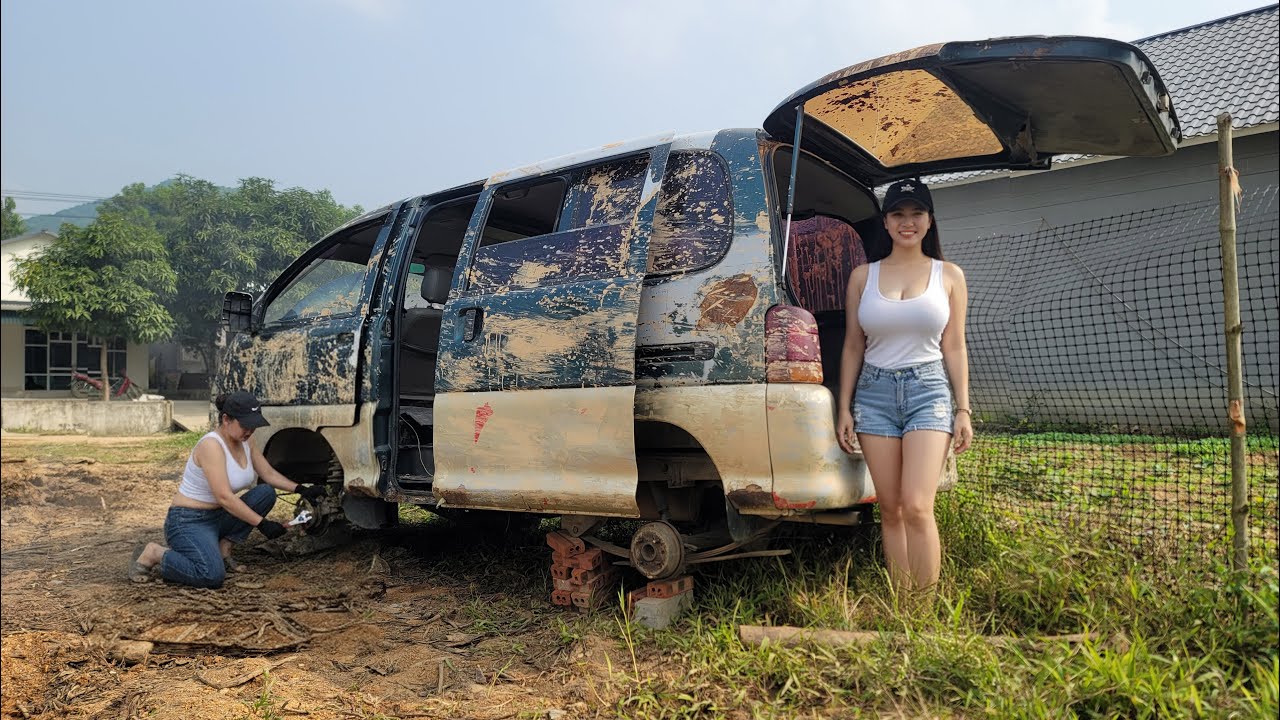 The girl repaired and restored the engine of the man's car used to transport grass for the cows