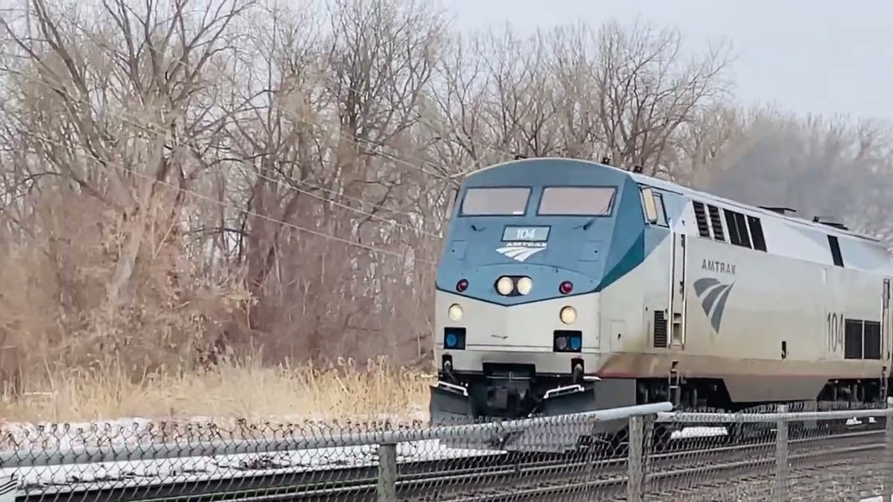 Amtrak 63 passing the mall and Onondaga lake led by 104