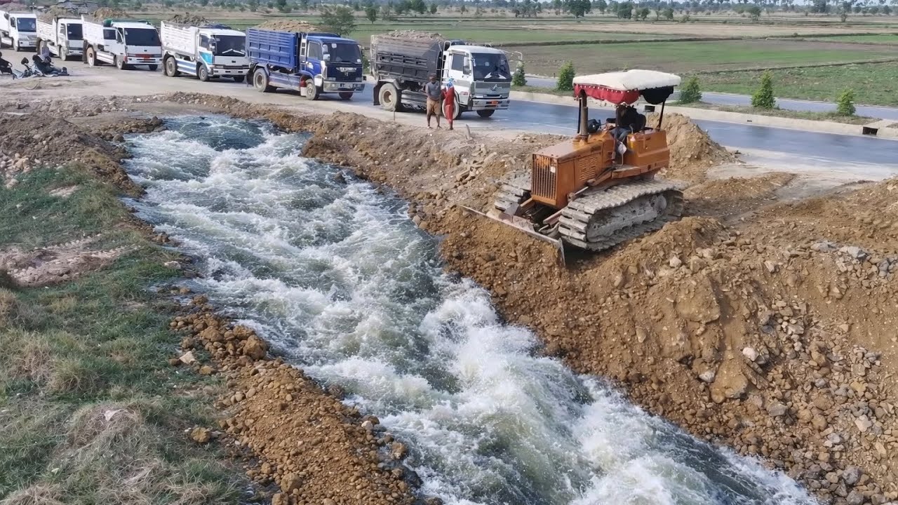 Small Bulldozer Pushing Soil Filling Land With 5T Dump Trucks