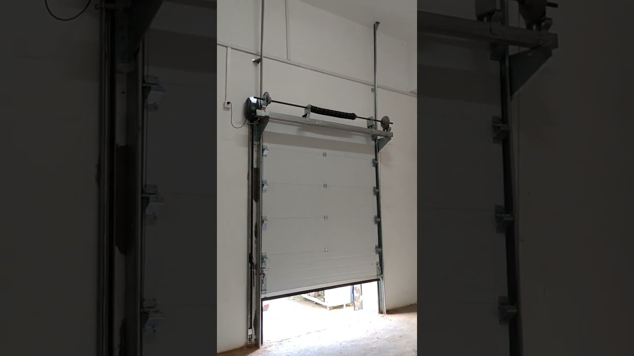 Sectional garage doors with side mounted motors