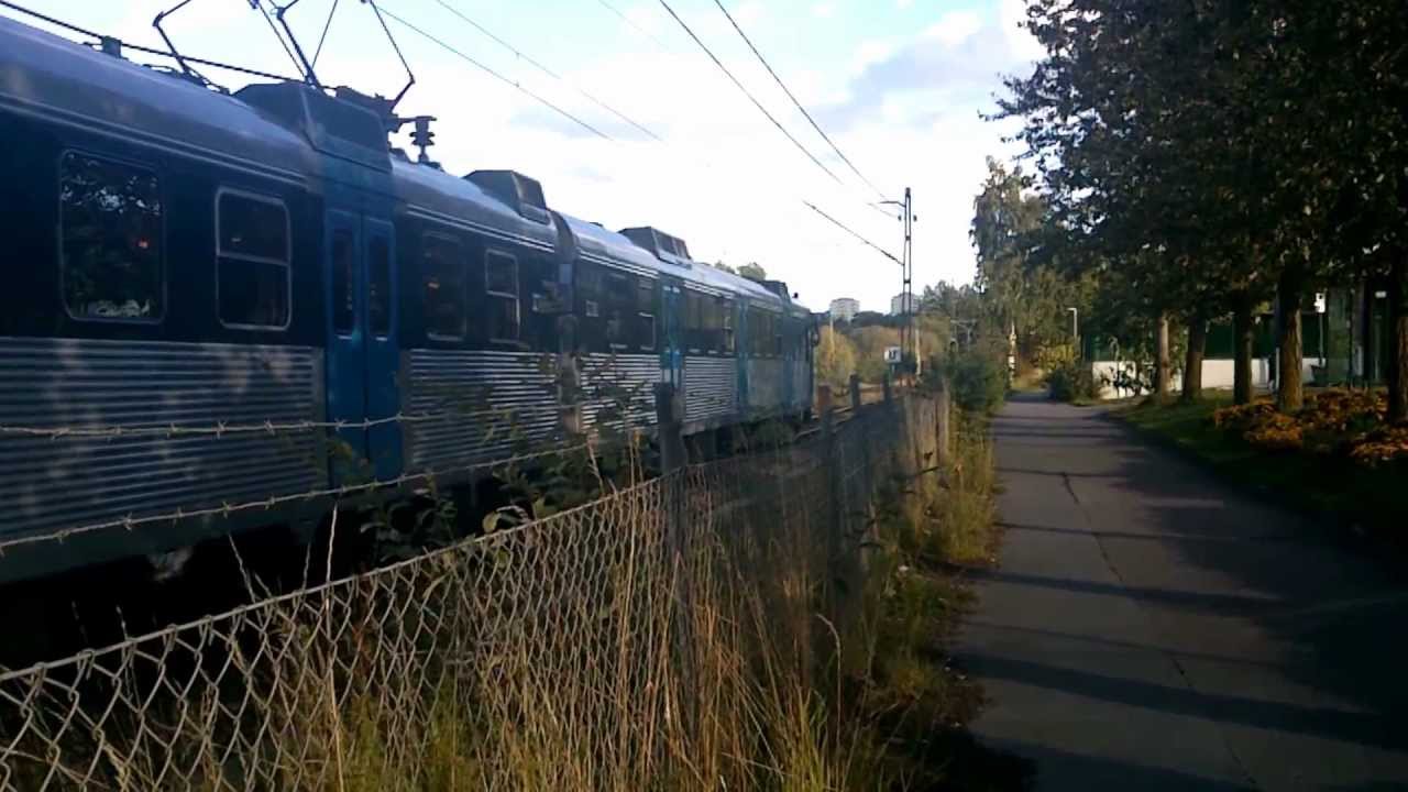 X10 Commuter train arrives and departs from Barkarby Station in Stockholm.