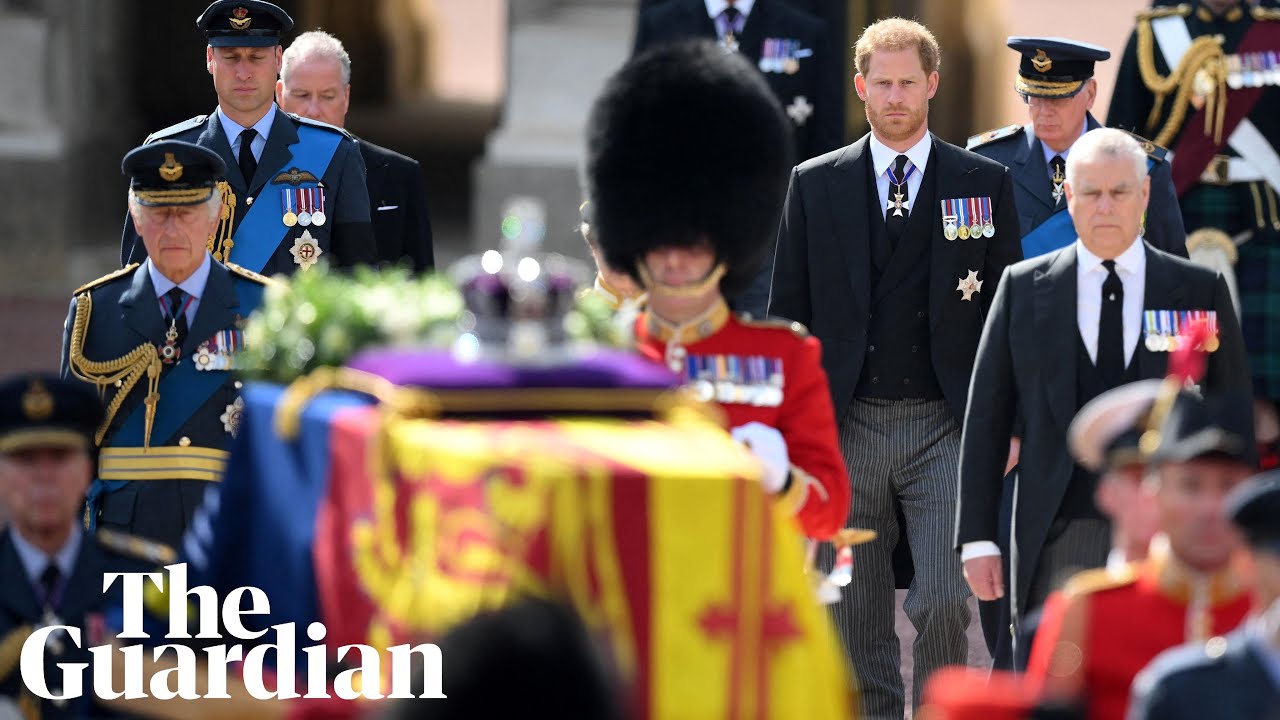 Royal family members walk behind Queen's coffin along the Mall in London