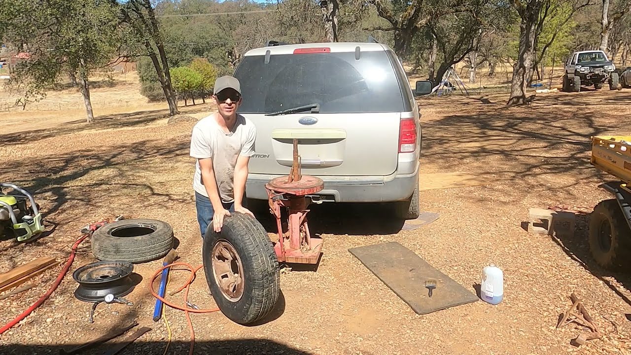 Replacing the tire on my dump trailer using the manual tire changer.