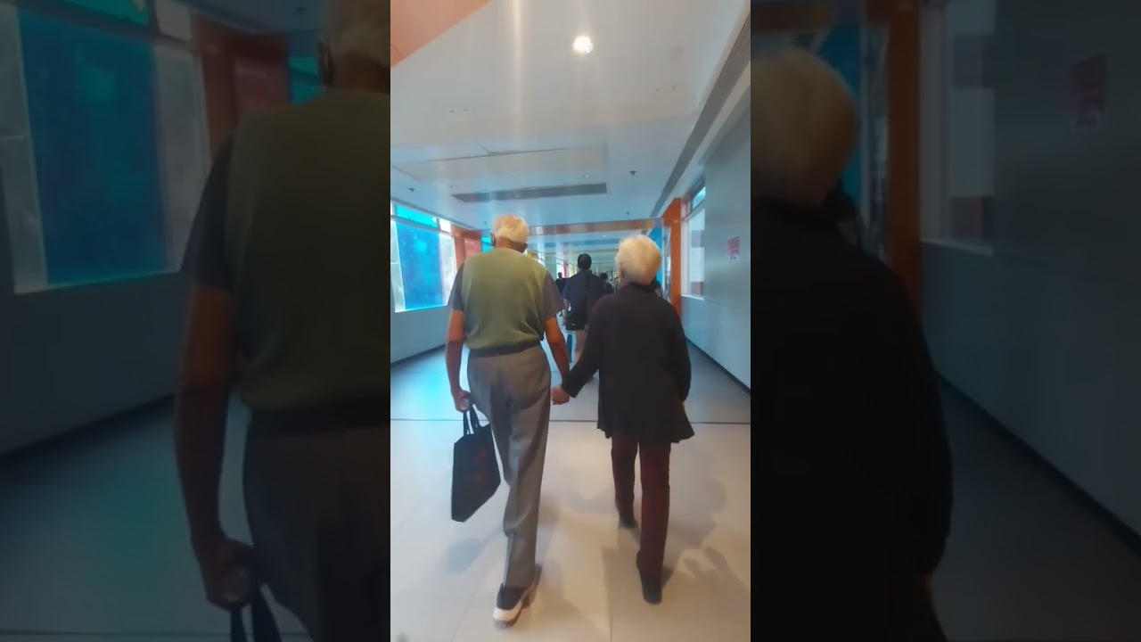 Old couple holding hands while walking