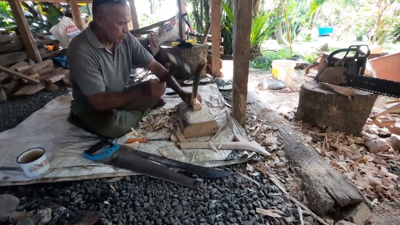 Alatina Avamua Matamua carves a wood handle for a Samoan stone adze