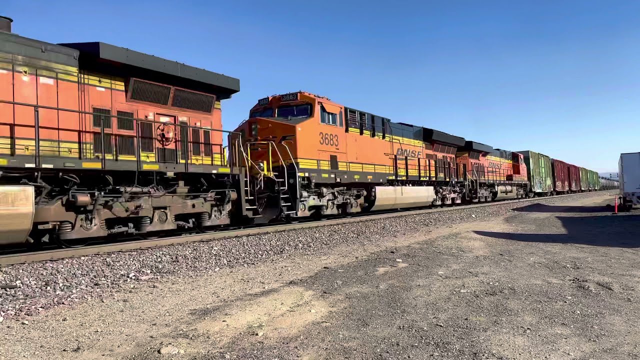 4K Three trains meet up!  BNSF Intermodal ties down for a crew change and in the meantime is passed